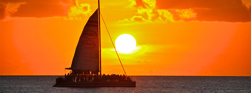 sailing catamaran at sunset